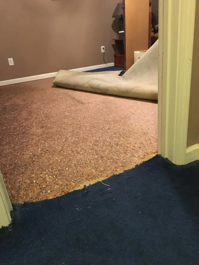 Carpet pad removal revealing water damage during Water Mitigation Services in South Sioux City